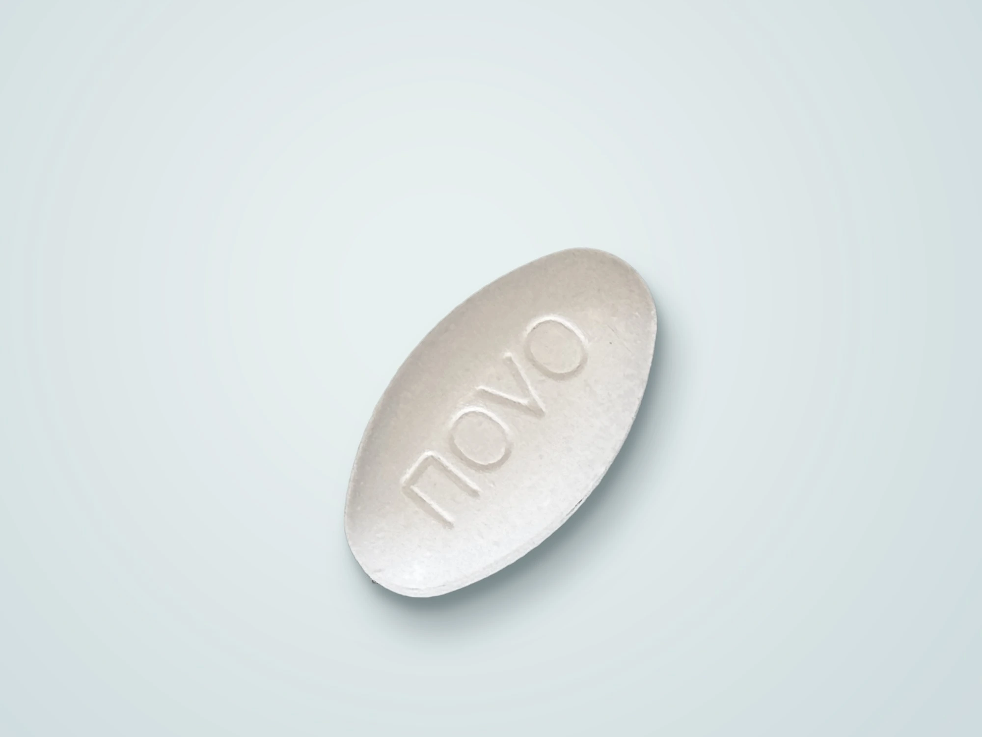 A white tablet on a light, soft blue background